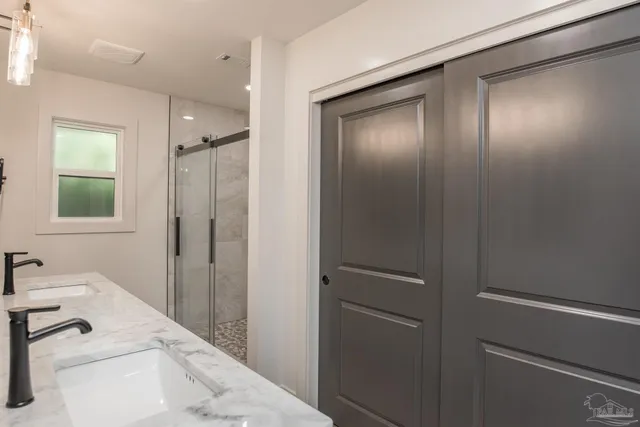 a bathroom with a granite countertop toilet sink and mirror
