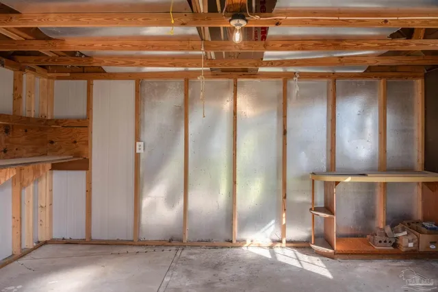 a view of a house with garden and a tree