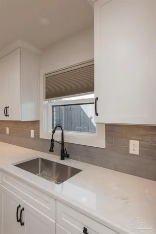a kitchen with a sink and cabinets