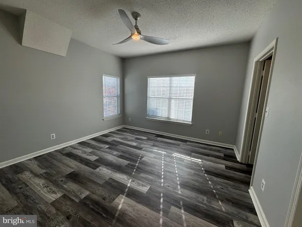 a view of an empty room and wooden floor