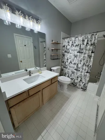 a bathroom with a sink toilet and mirror