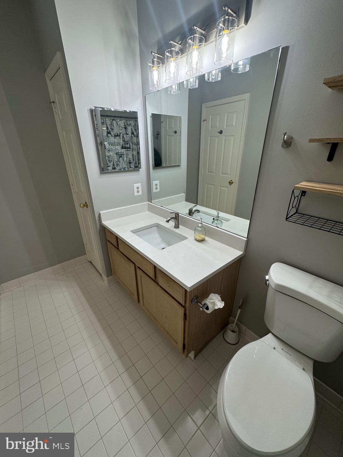 1716 Lake Shore Crest Drive, Unit 32 Reston, VA 20190 - Photo 19 of 40 a bathroom with a sink toilet and mirror