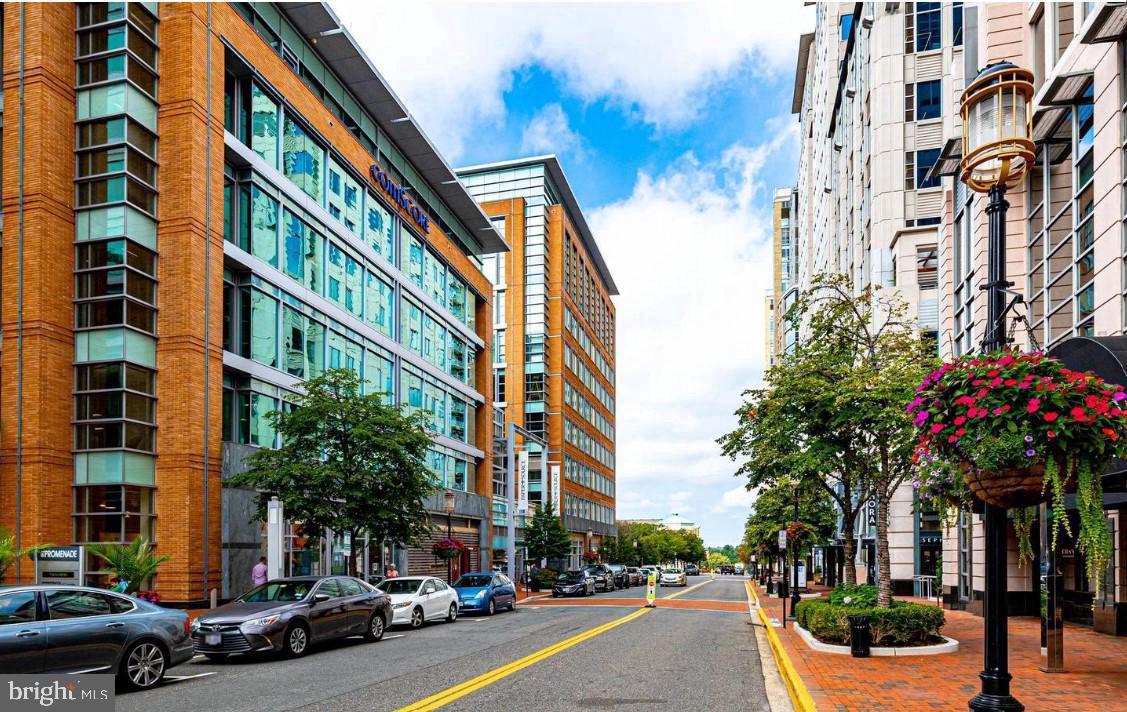 1716 Lake Shore Crest Drive, Unit 32 Reston, VA 20190 - Photo 36 of 37 a city street lined with buildings and cars