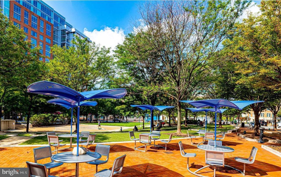 1716 Lake Shore Crest Drive, Unit 32 Reston, VA 20190 - Photo 38 of 40 a view of a chairs and table under an umbrella in patio