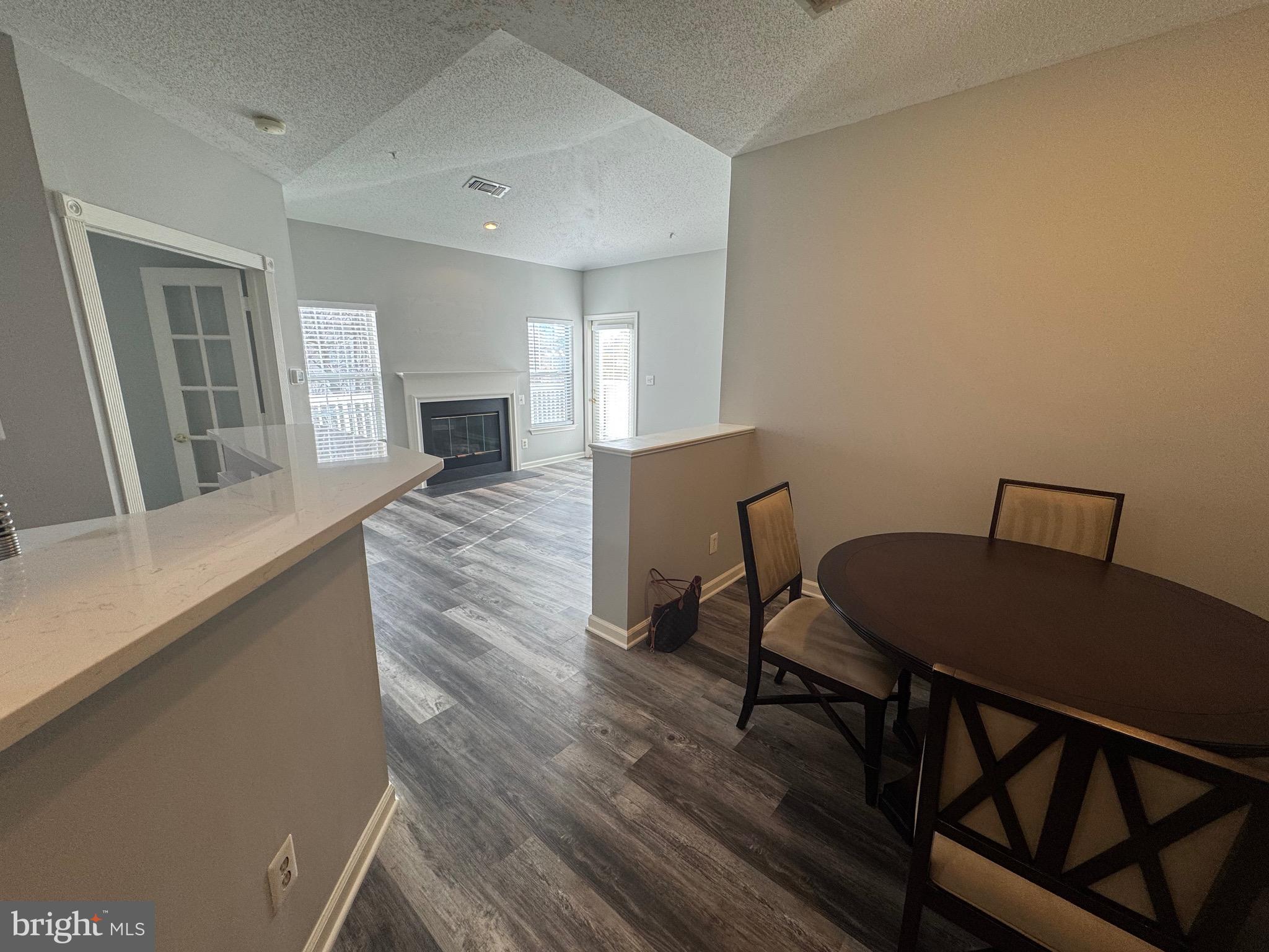 1716 Lake Shore Crest Drive, Unit 32 Reston, VA 20190 - Photo 6 of 40 a view of a dining room with furniture and wooden floor