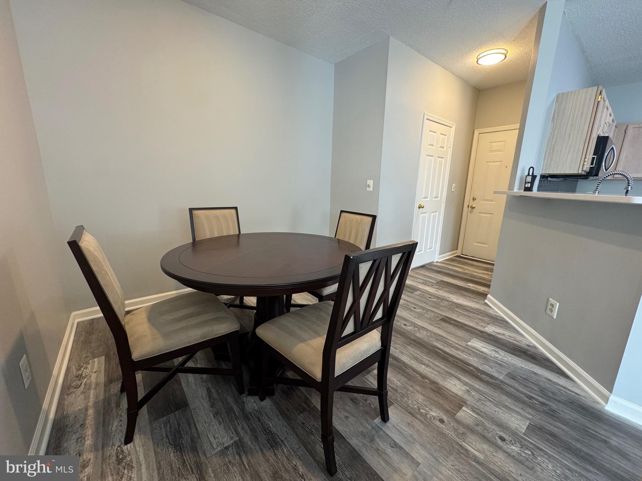 1716 Lake Shore Crest Drive, Unit 32 Reston, VA 20190 - Photo 7 of 40 a view of a dining room with furniture and wooden floor