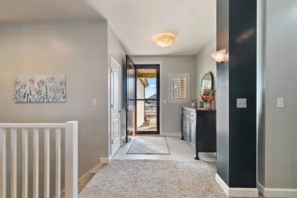 a view of a hallway with wooden floor and windows