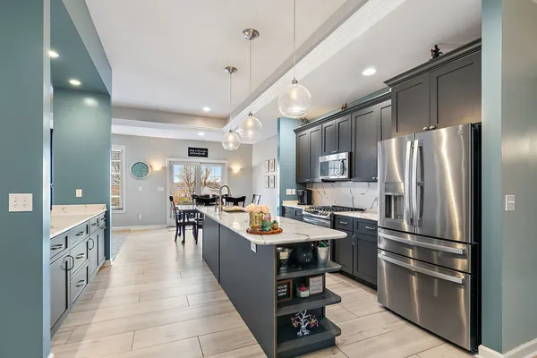 a large kitchen with stainless steel appliances lots of counter top space