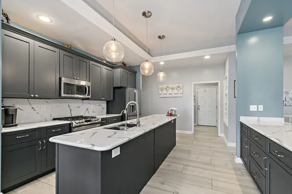 a kitchen with a sink a counter space and stainless steel appliances
