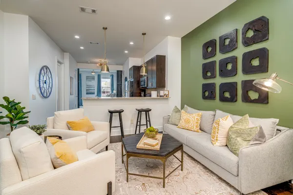 a living room with furniture and wooden floor