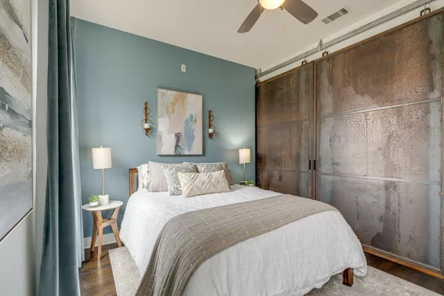 a bedroom with a bed and a chandelier