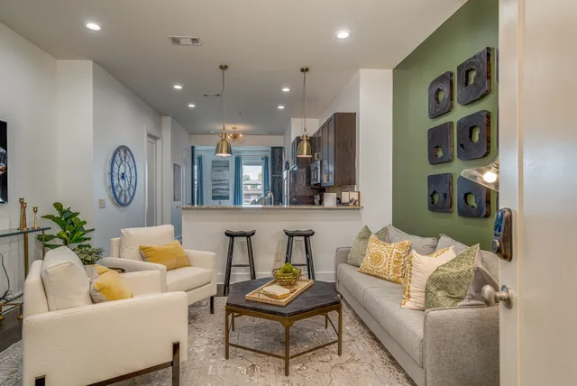 a living room with furniture and a wooden floor