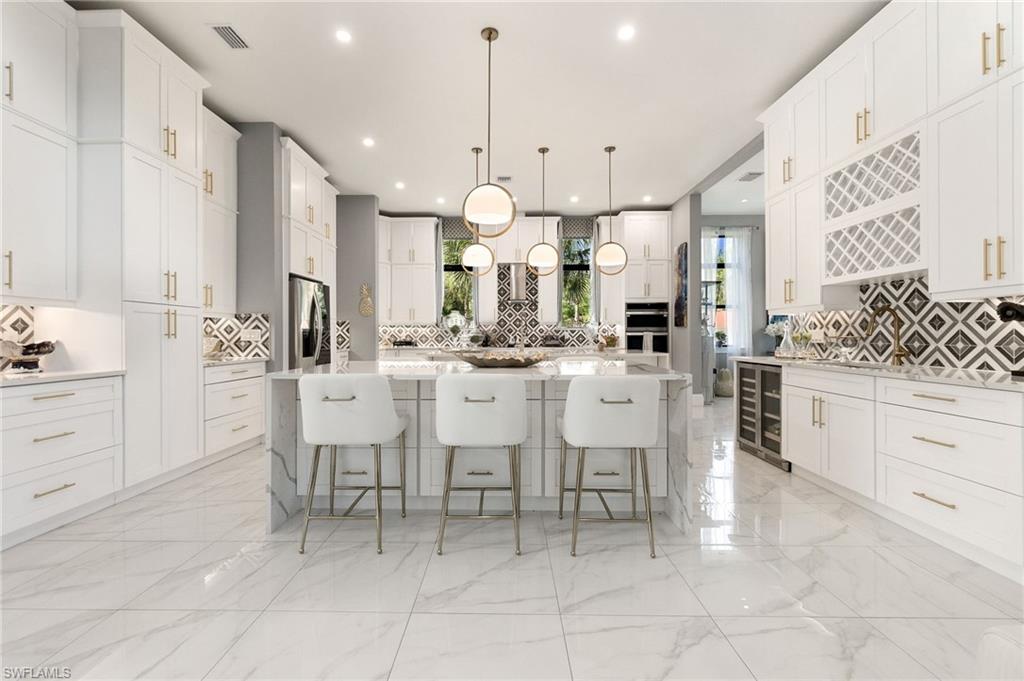 2227 21st Street Southwest Naples, FL 34117 - Photo 12 of 50 a large kitchen with a large counter top space appliances and cabinets