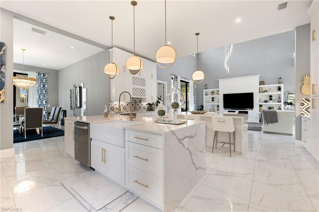 2227 21st Street Southwest Naples, FL 34117 - Photo 13 of 50 a large kitchen with a sink and living room view