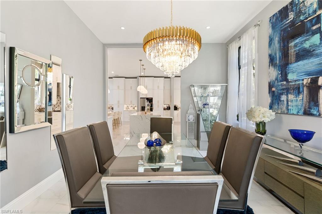2227 21st Street Southwest Naples, FL 34117 - Photo 18 of 50 a view of a dining room with furniture window and wooden floor