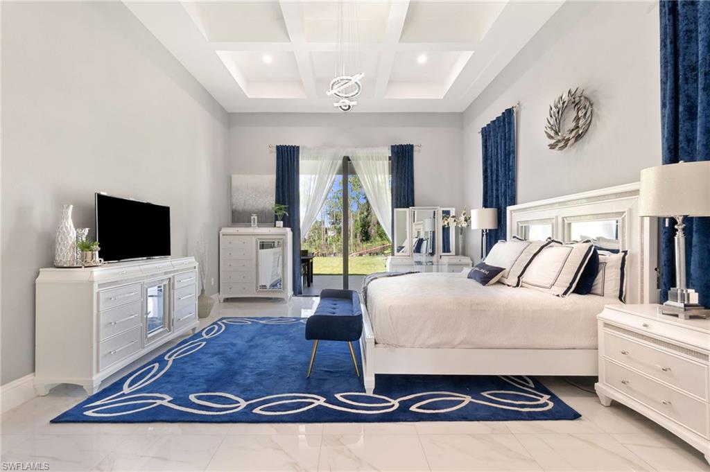 2227 21st Street Southwest Naples, FL 34117 - Photo 22 of 50 a living room with furniture and a flat screen tv