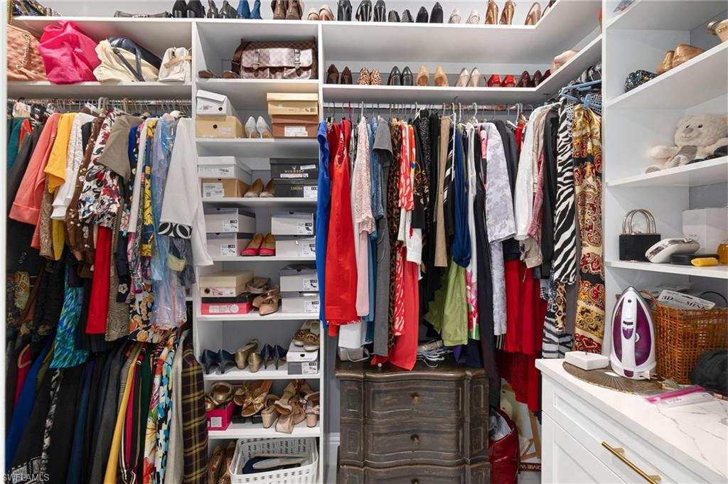 2227 21st Street Southwest Naples, FL 34117 - Photo 23 of 50 a view of walk in closet with clothes and shoes