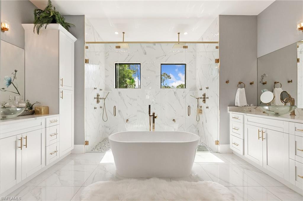 2227 21st Street Southwest Naples, FL 34117 - Photo 25 of 50 a spacious bathroom with a double vanity sink mirror and bathtub
