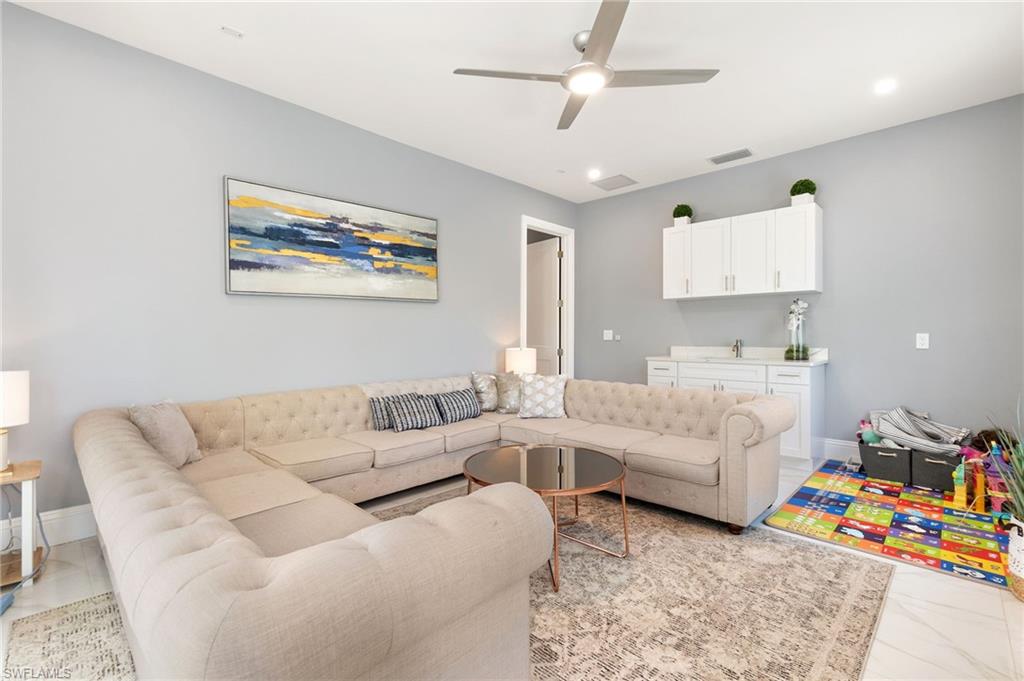 2227 21st Street Southwest Naples, FL 34117 - Photo 28 of 50 a living room with furniture and a baby crib
