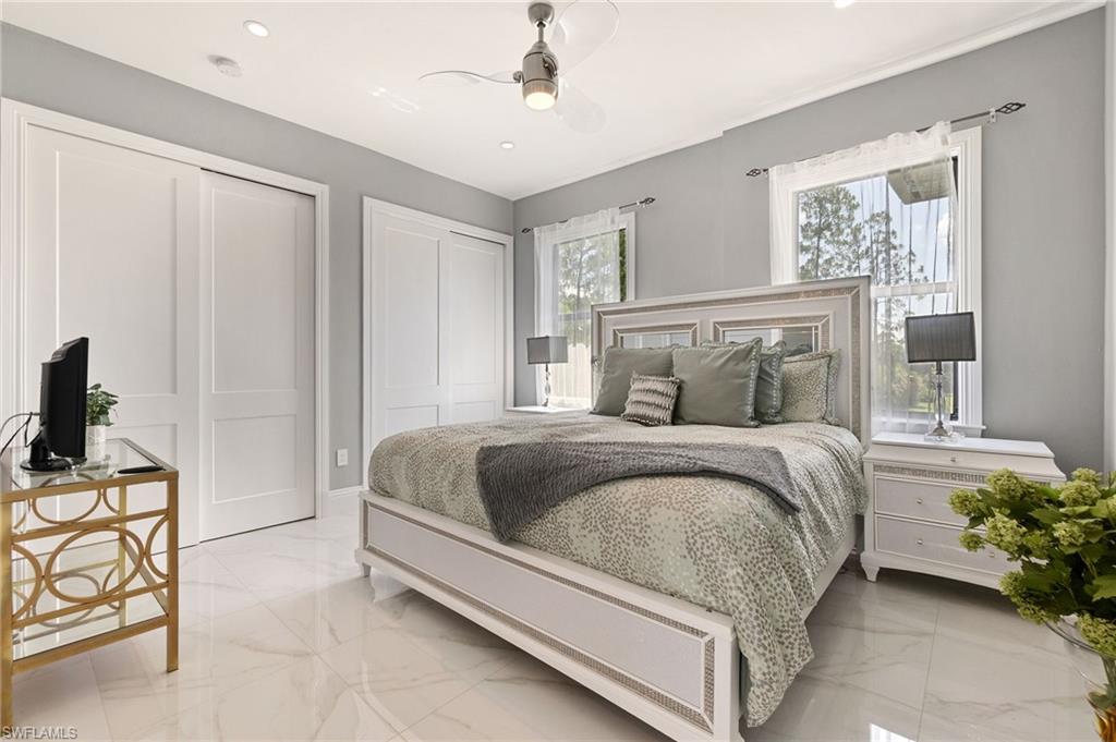 2227 21st Street Southwest Naples, FL 34117 - Photo 32 of 50 a bedroom with a bed and potted plant on the dresser