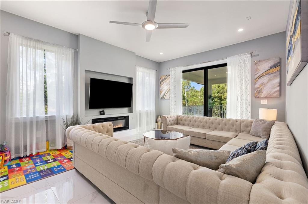 2227 21st Street Southwest Naples, FL 34117 - Photo 37 of 50 a living room with furniture and a flat screen tv