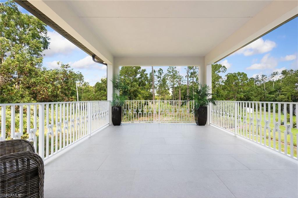 2227 21st Street Southwest Naples, FL 34117 - Photo 38 of 50 a view of a roof deck with a floor to ceiling window and wooden fence