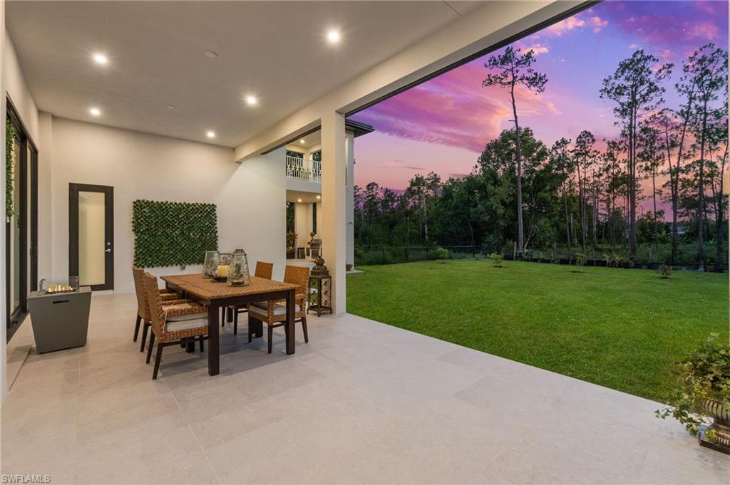 2227 21st Street Southwest Naples, FL 34117 - Photo 44 of 50 a view of a patio with a table and chairs