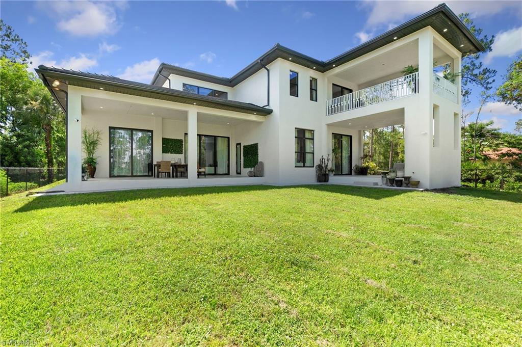 2227 21st Street Southwest Naples, FL 34117 - Photo 45 of 50 front view of a house with a yard