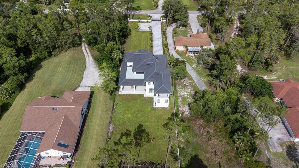 2227 21st Street Southwest Naples, FL 34117 - Photo 48 of 50 an aerial view of residential houses with outdoor space and trees
