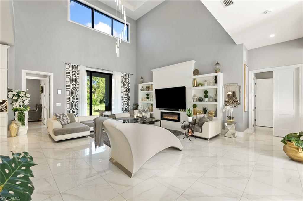 2227 21st Street Southwest Naples, FL 34117 - Photo 6 of 50 a living room with furniture and a flat screen tv