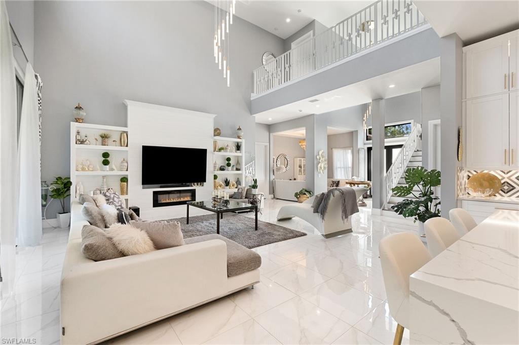 2227 21st Street Southwest Naples, FL 34117 - Photo 8 of 50 a living room with furniture and a flat screen tv
