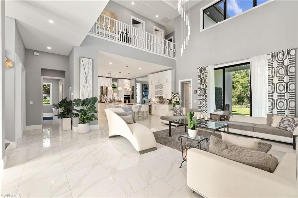 2227 21st Street Southwest Naples, FL 34117 - Photo 9 of 50 a living room with furniture and a large window