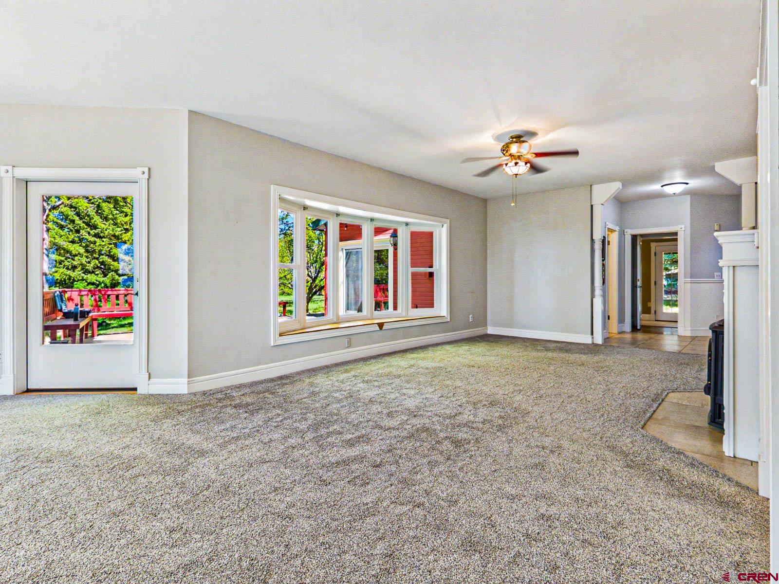 16331 2550th Road Cedaredge, CO 81413 - Photo 12 of 45 an empty room with windows and ceiling fan