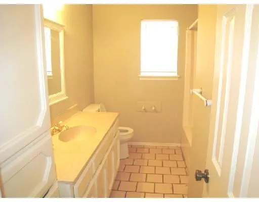 a bathroom with a granite countertop shower and a sink