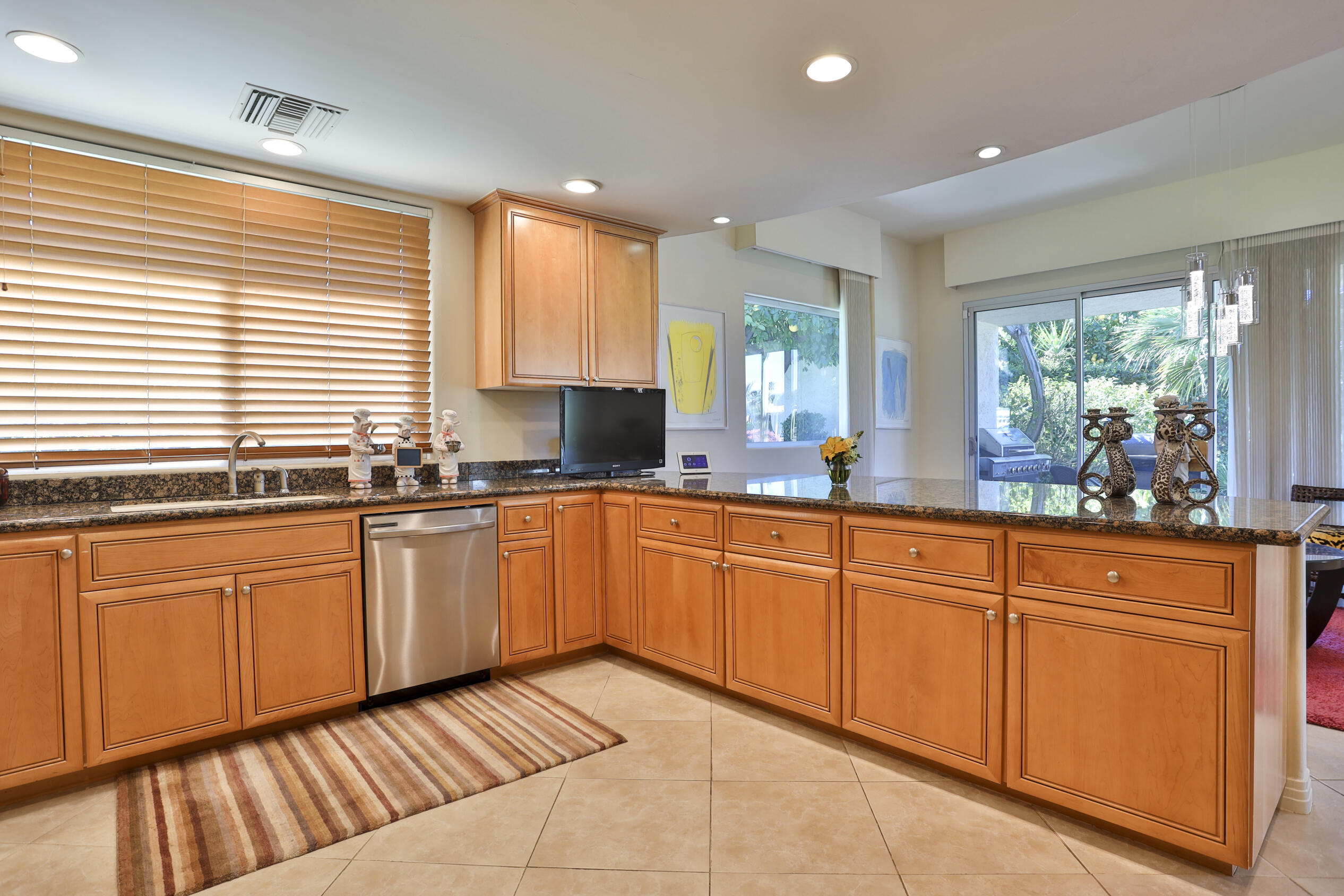 45735 Pawnee Road Indian Wells, CA 92210 - Photo 21 of 74 a large kitchen with granite countertop cabinets and a sink