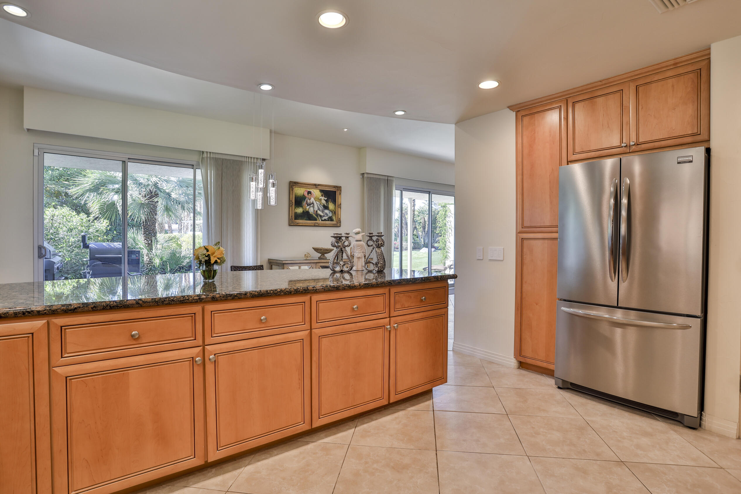 45735 Pawnee Road Indian Wells, CA 92210 - Photo 22 of 74 a kitchen with stainless steel appliances granite countertop a refrigerator and a sink