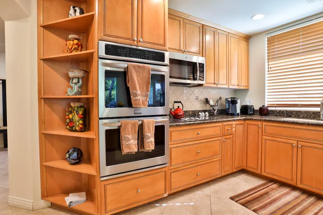 a living room with dining room and a chandelier