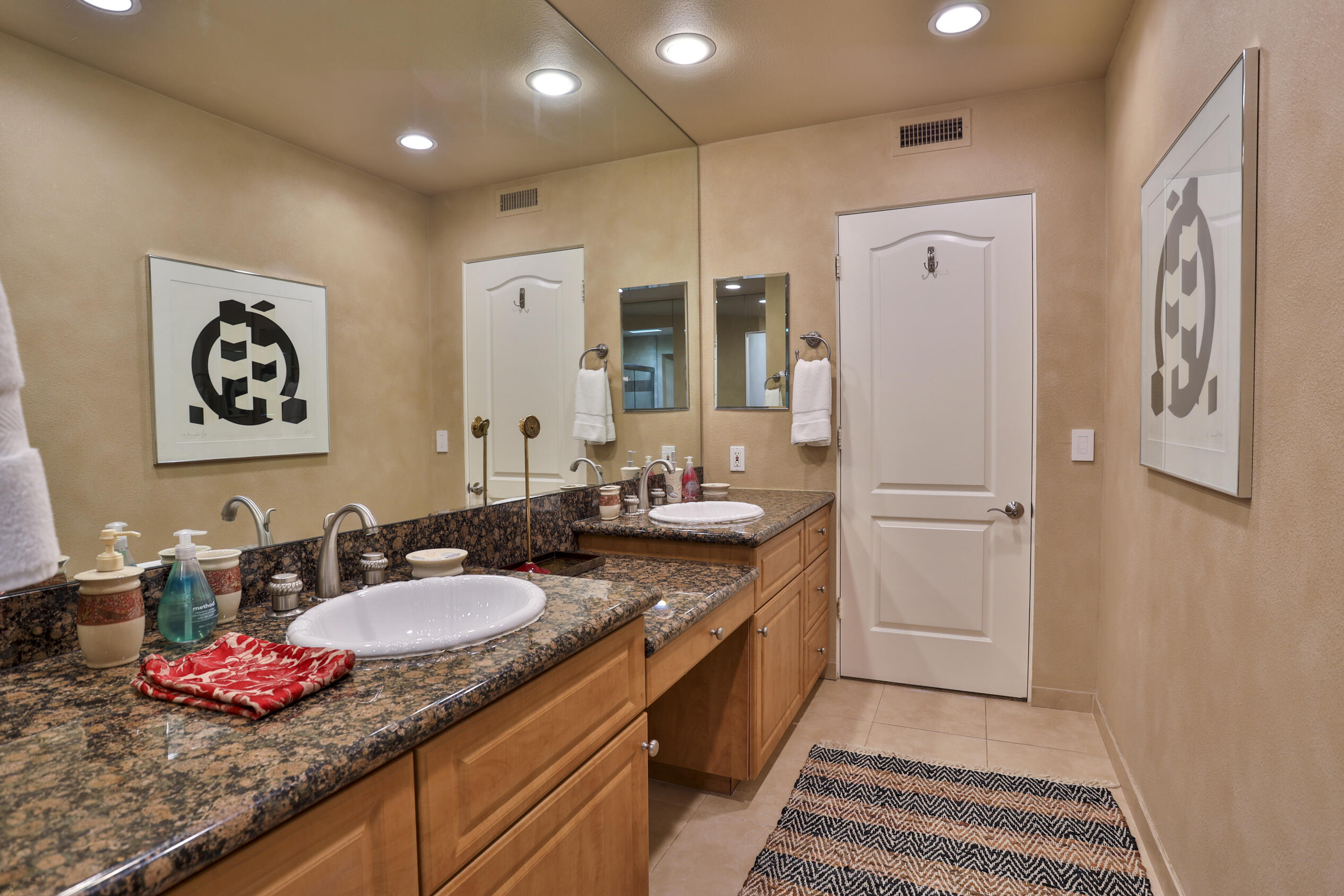 45735 Pawnee Road Indian Wells, CA 92210 - Photo 47 of 74 a spacious bathroom with a granite countertop sink and a mirror