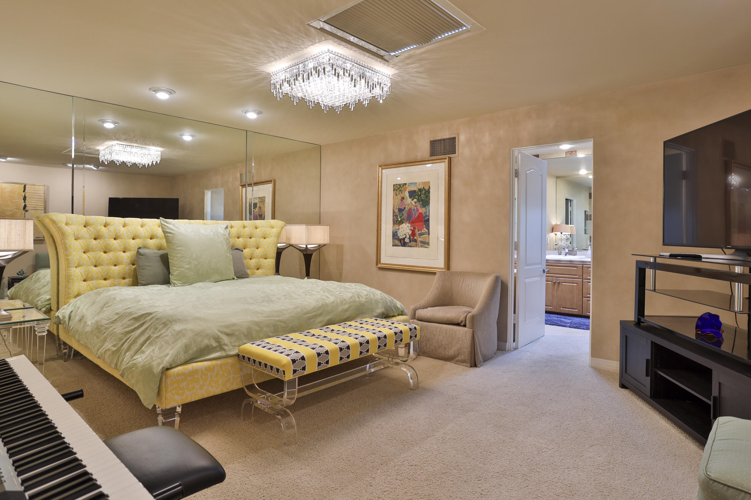 45735 Pawnee Road Indian Wells, CA 92210 - Photo 50 of 74 a bedroom with a bed and a chandelier