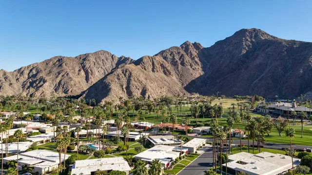 a view of a livingroom with furniture and a window