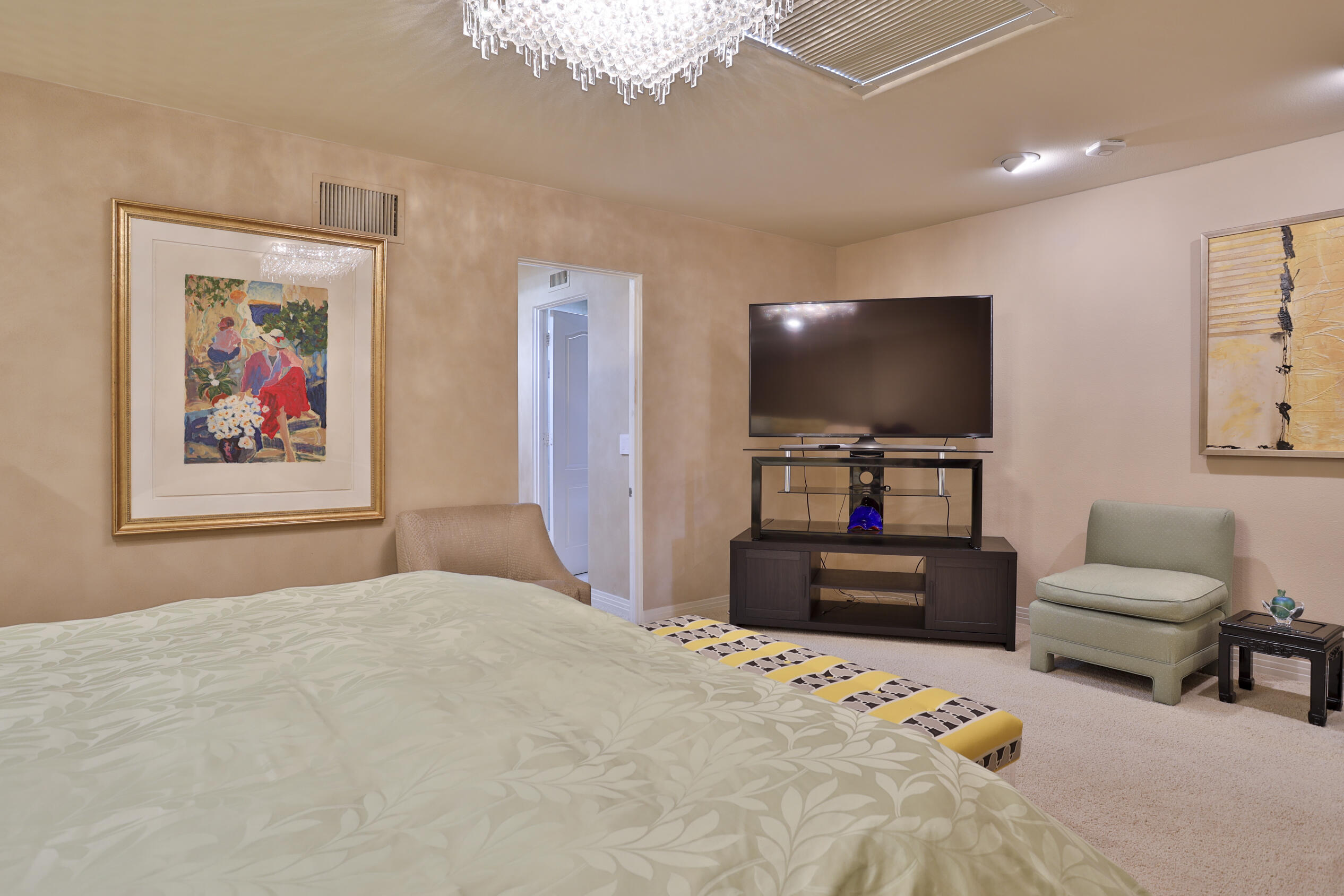 45735 Pawnee Road Indian Wells, CA 92210 - Photo 52 of 74 a bedroom with furniture and a flat screen tv