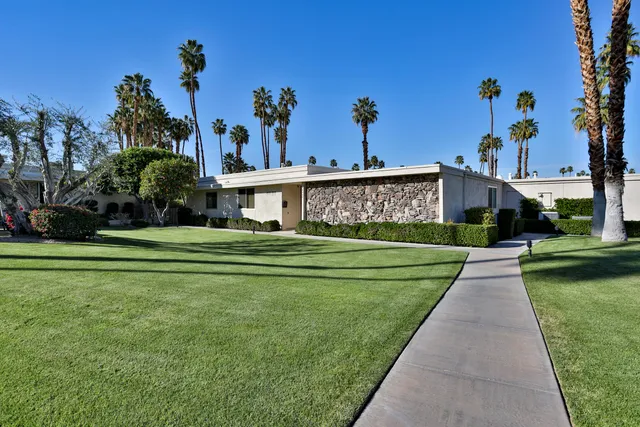 a living room with furniture kitchen view and a table