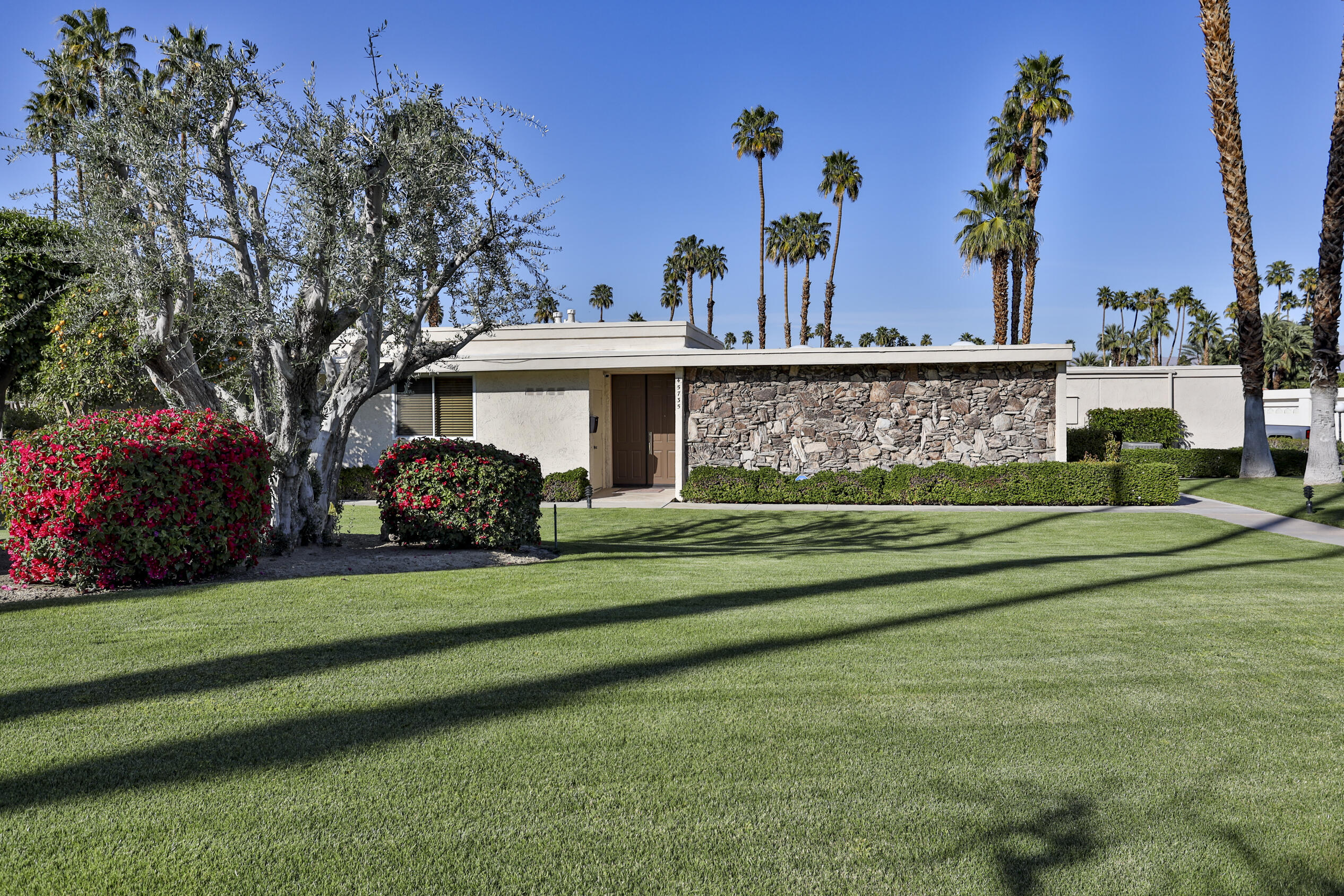 45735 Pawnee Road Indian Wells, CA 92210 - Photo 10 of 74 a front view of a house with a garden