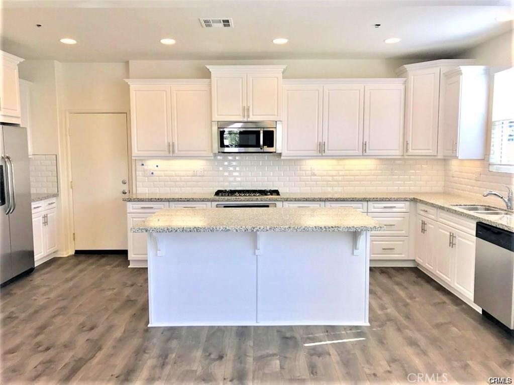 125 Fixie Irvine, CA 92618 - Photo 9 of 28 a kitchen with stainless steel appliances granite countertop a sink and cabinets