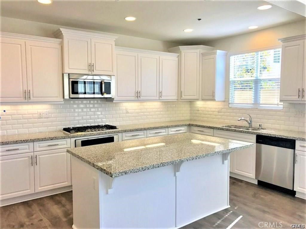 125 Fixie Irvine, CA 92618 - Photo 10 of 28 a kitchen with granite countertop a sink stove and cabinets