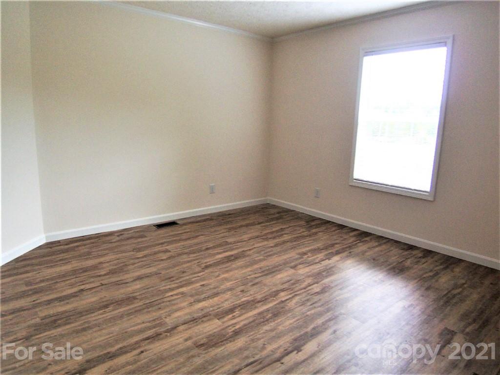 3808 Fallston Road Shelby, NC 28150 - Photo 14 of 18 an empty room with wooden floor and windows