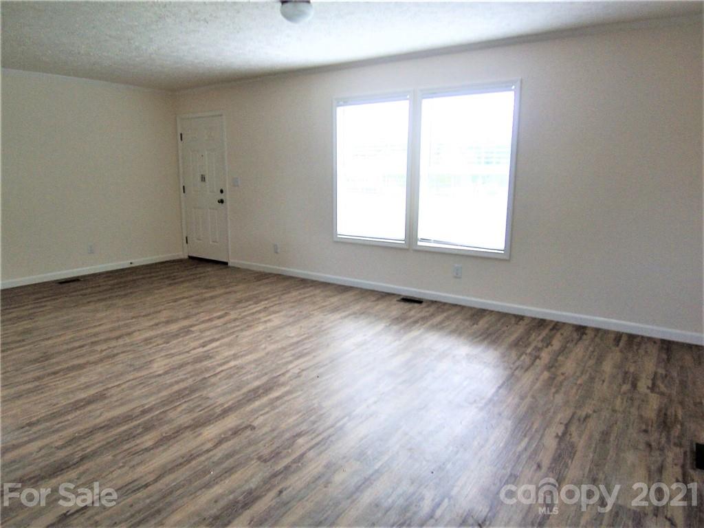 3808 Fallston Road Shelby, NC 28150 - Photo 3 of 18 an empty room with wooden floor and windows
