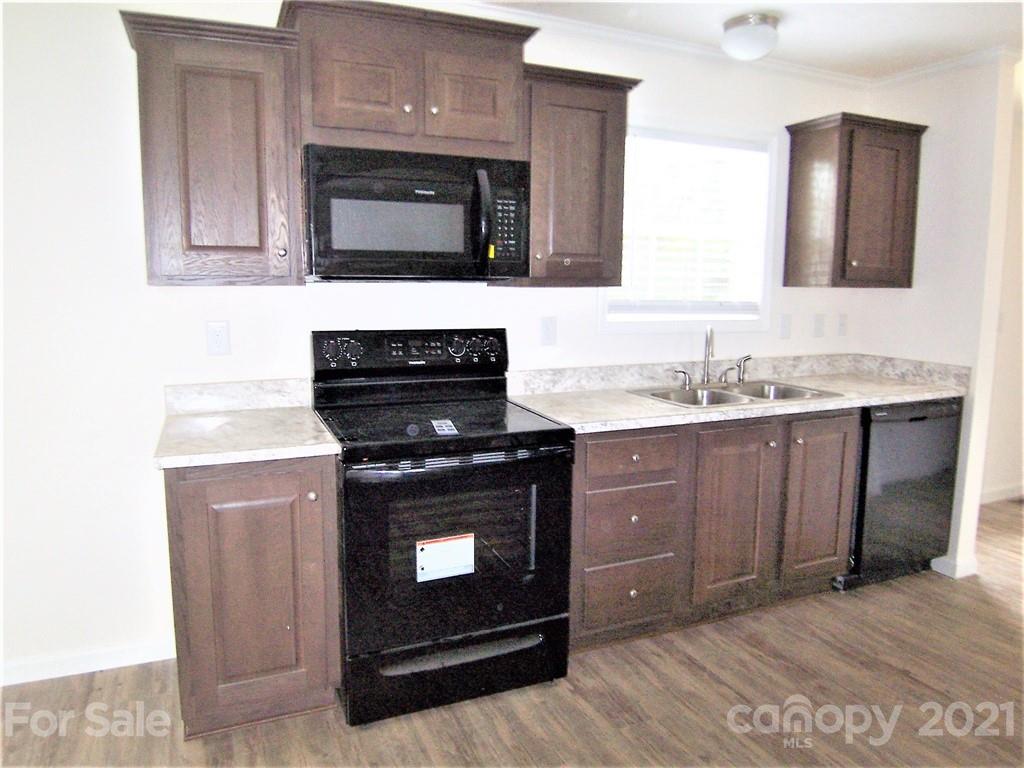 3808 Fallston Road Shelby, NC 28150 - Photo 7 of 18 a kitchen with stainless steel appliances granite countertop a stove microwave and sink