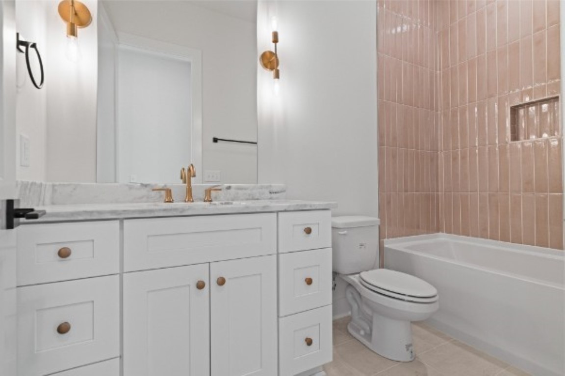 603 Morrow Road, Unit A Nashville, TN 37209 - Photo 16 of 38 a bathroom with a toilet sink vanity tub and shower