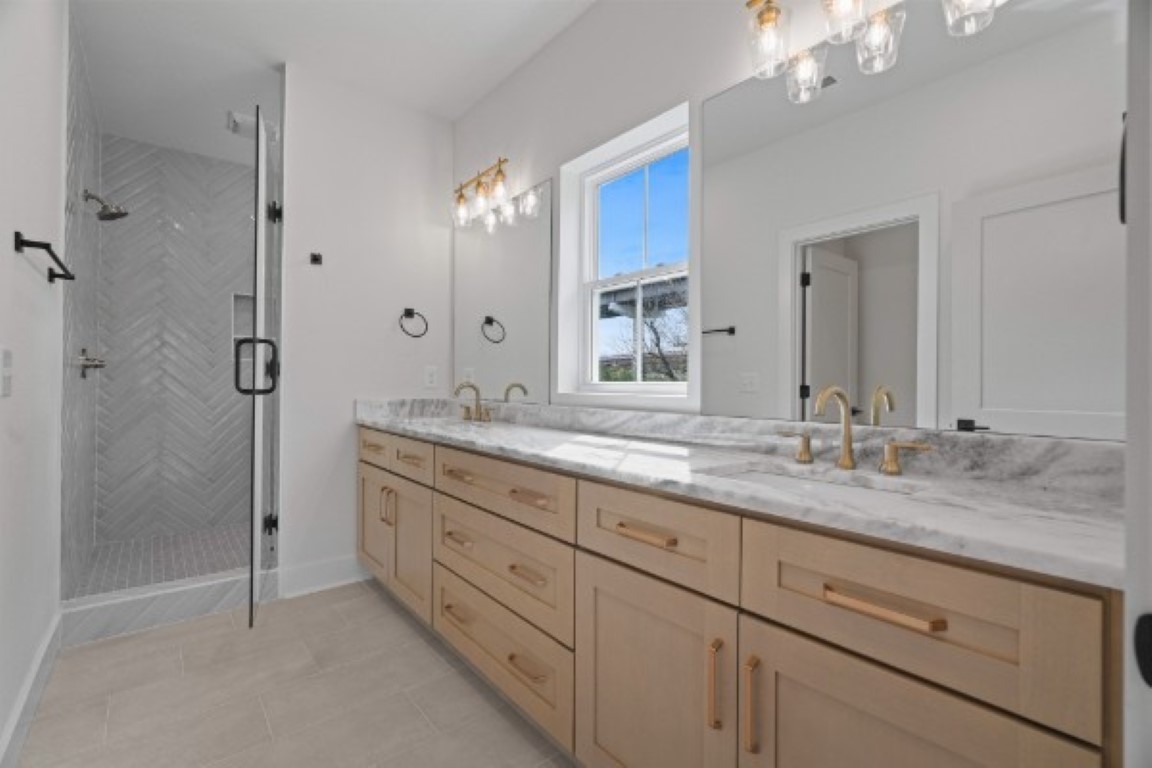 603 Morrow Road, Unit A Nashville, TN 37209 - Photo 24 of 38 a bathroom with a granite countertop double vanity sink mirror shower and